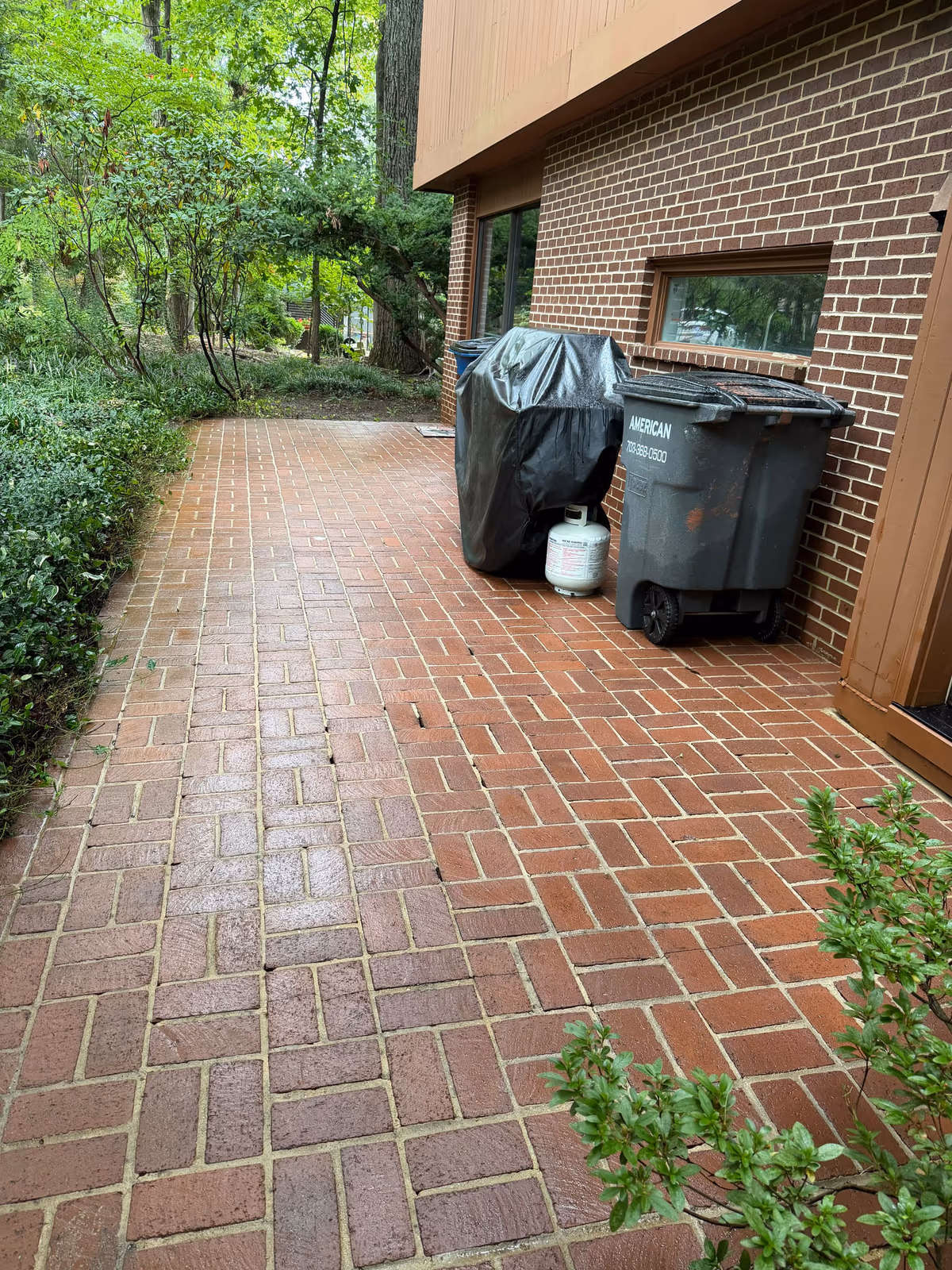 The same brick paver driveway after power washing, back to its original red colour