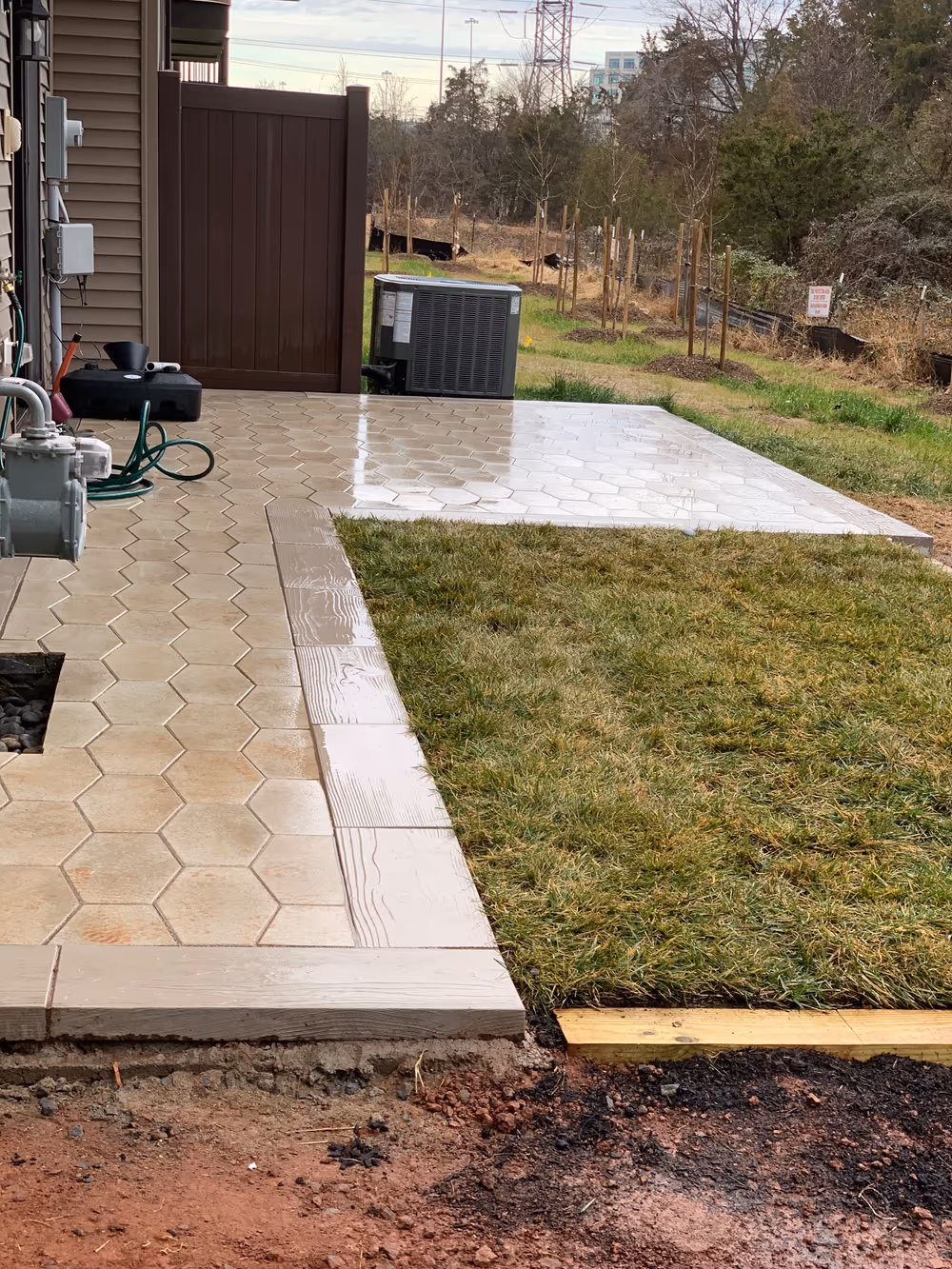 Finished hexagonal paver patio and walkway with new sod laid alongside