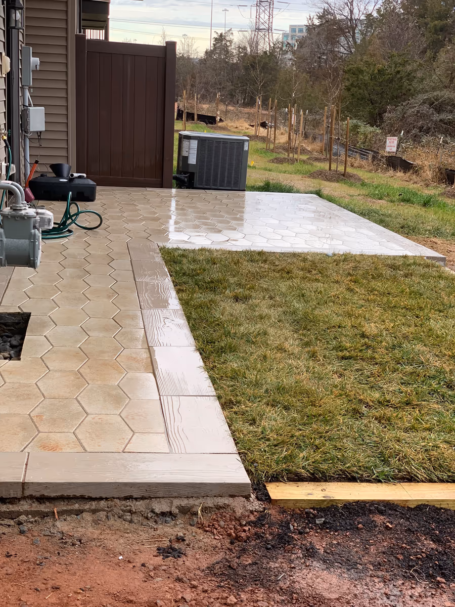 Finished hexagonal paver patio and walkway with new sod laid alongside